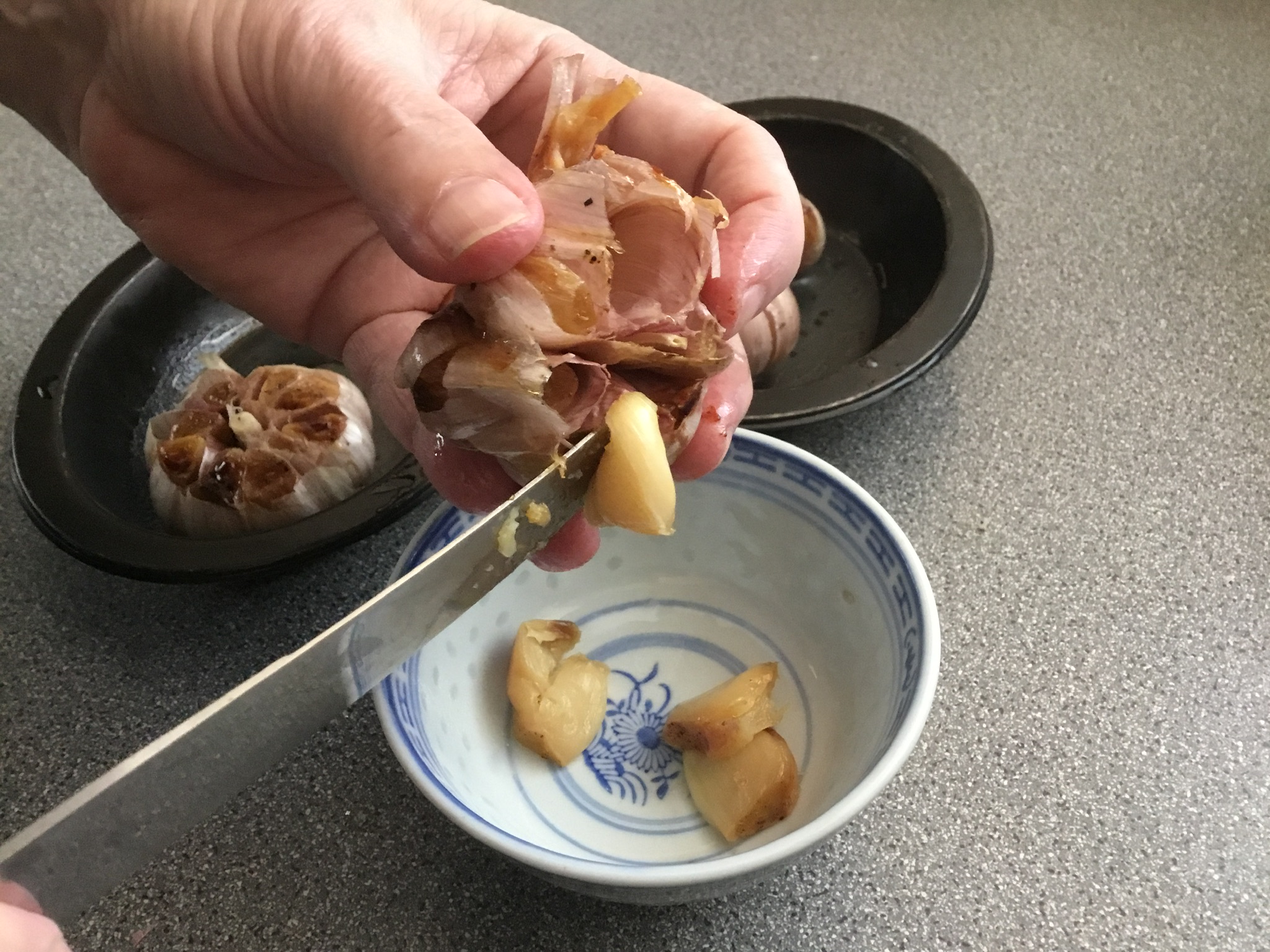 Removing the roasted garlic cloves from the head