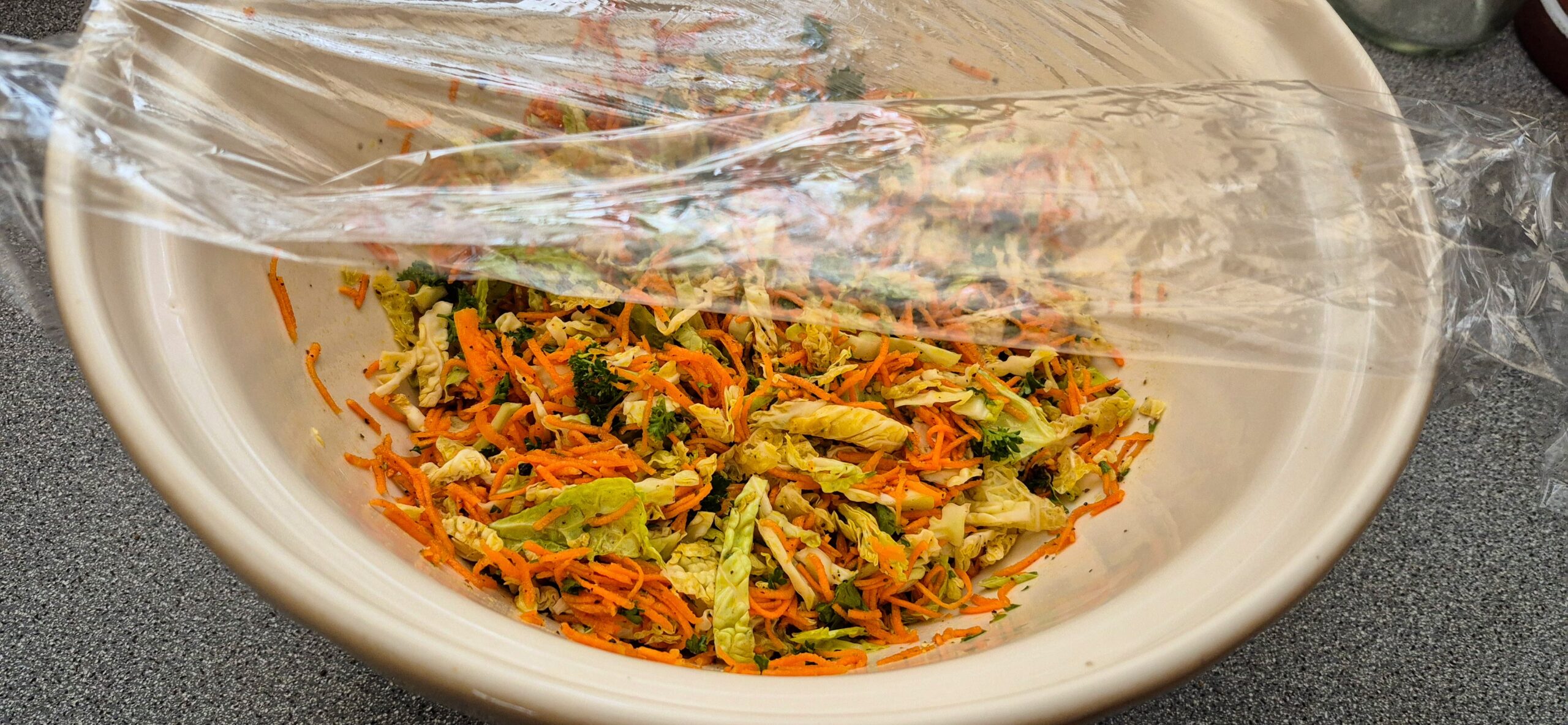 The salad and its dressing sit quietly and compose themselves